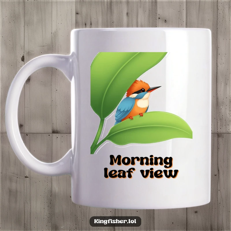 Funny Kingfisher Mug: A cute kingfisher peeking mischievously from behind a large green leaf, a funny and endearing scene.