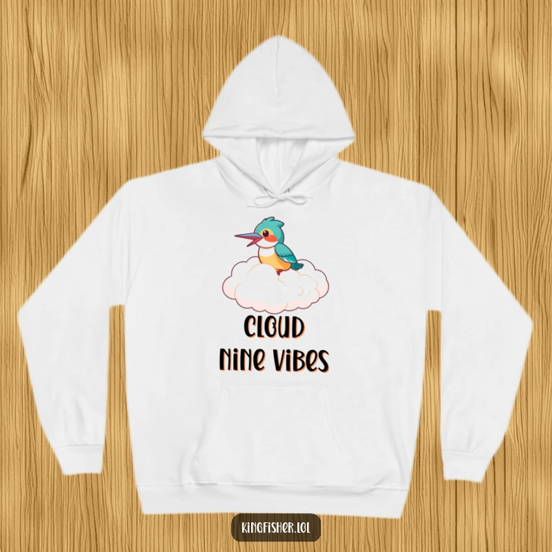 Funny Hoodie: A laughing kingfisher bird perched comfortably on a fluffy cloud, offering cozy warmth and hilarious adventure.