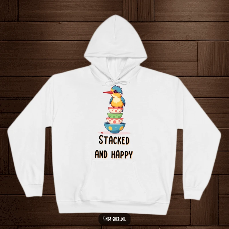 Funny hoodie with a giggling kingfisher bird balancing a stack of colorful, wobbling food bowls, perfect for cozy food enjoyment.