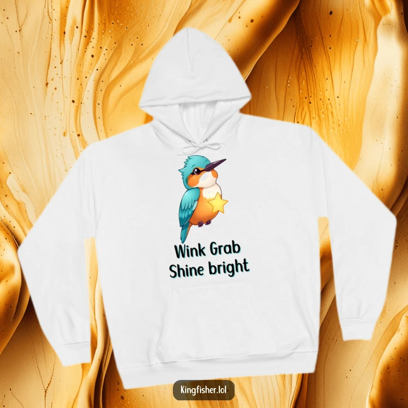 Funny kingfisher winks, holding a glowing star, on a comfortable hoodie, radiating celestial humor.