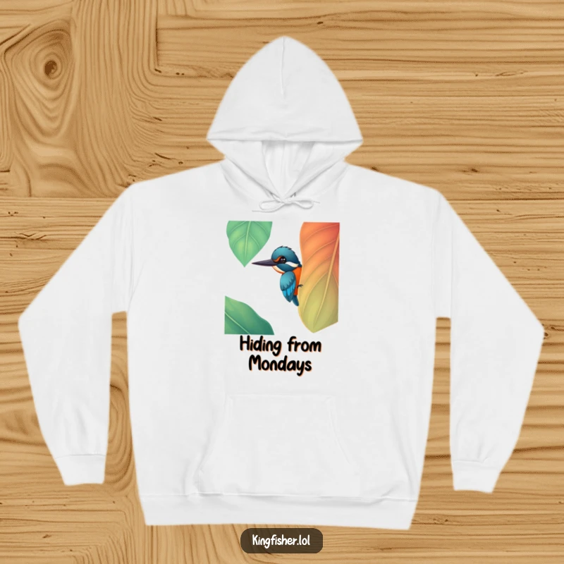 Funny cheerful kingfisher bird peeking from behind a big, colorful leaf on a soft hoodie, a great funny gift.