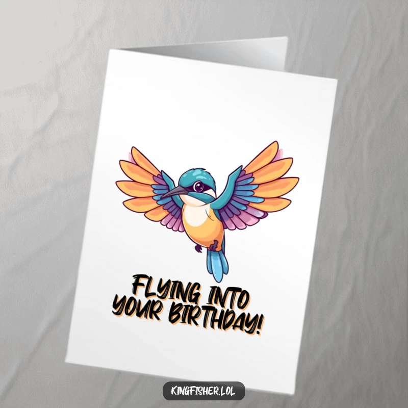 Free printable birthday card: A kawaii kingfisher bird in mid-flight with wings spread wide, trailing colorful feathers, offering energetic wishes.