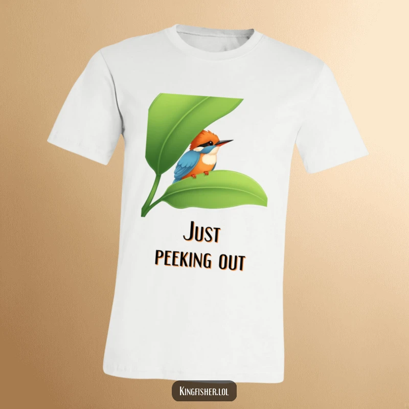 Funny Kingfisher T-Shirt: A cute kingfisher peeking from behind a lush green leaf, designed for a funny and charming look.