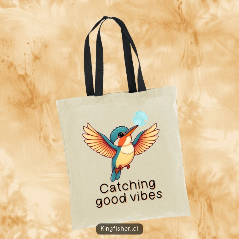 Funny kingfisher bird tote bag with outstretched wings, playfully interacting with a floating bubble, perfect for carrying items with style.